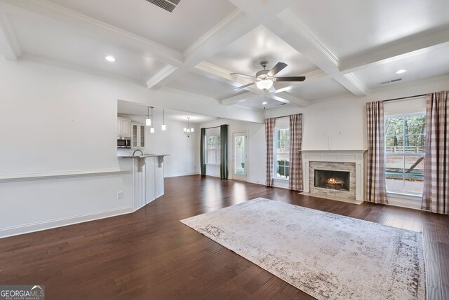 unfurnished living room featuring dark wood-type flooring, coffered ceiling, and a fireplace