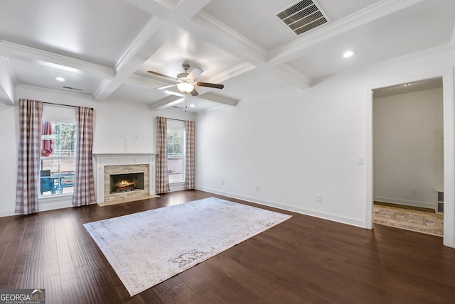 unfurnished living room featuring coffered ceiling, a healthy amount of sunlight, dark wood-type flooring, and a fireplace