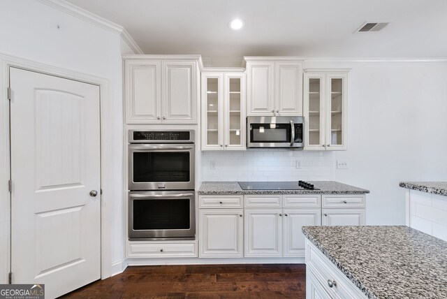 kitchen featuring stainless steel appliances, tasteful backsplash, white cabinets, and crown molding