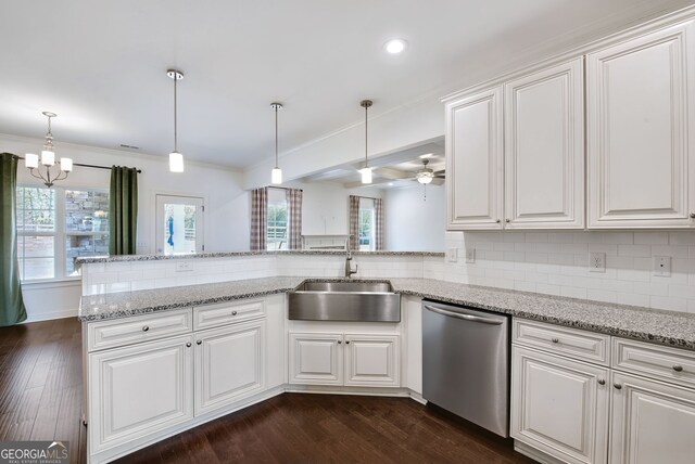 kitchen with white cabinetry, sink, stainless steel dishwasher, and kitchen peninsula