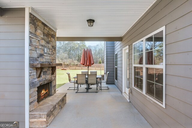 view of patio with an outdoor stone fireplace