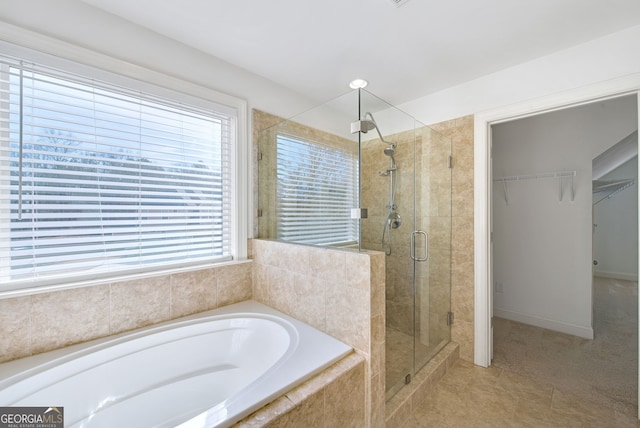 bathroom featuring separate shower and tub