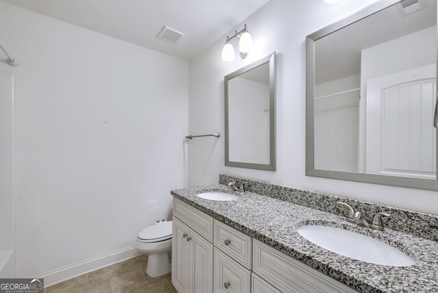 bathroom with vanity, tile patterned floors, and toilet