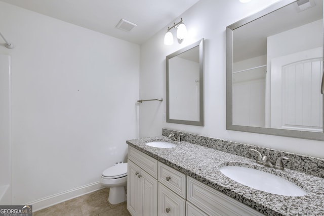 bathroom featuring tile patterned floors, vanity, and toilet