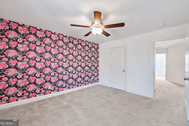 interior space featuring ceiling fan and light colored carpet