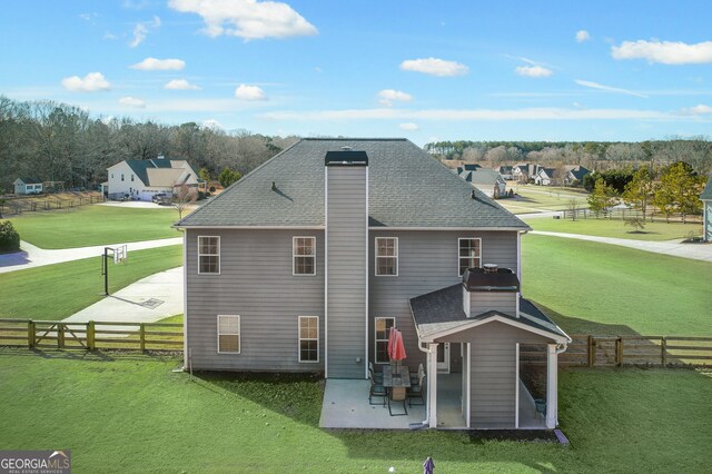 back of property featuring a yard and a patio