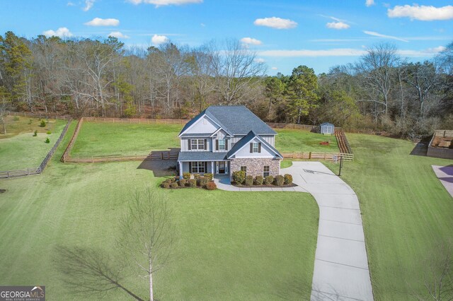 view of front of house with covered porch and a front lawn