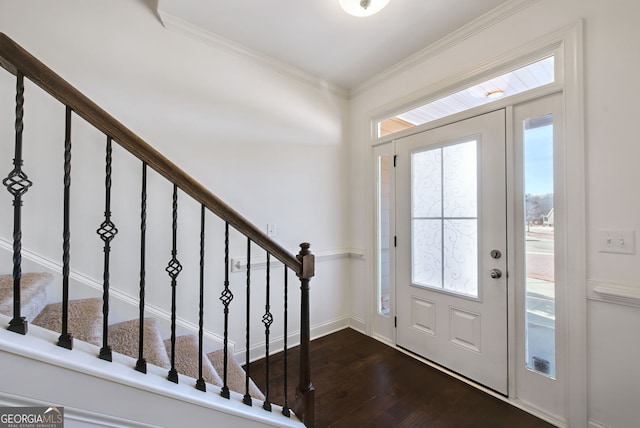 foyer featuring ornamental molding and dark hardwood / wood-style flooring