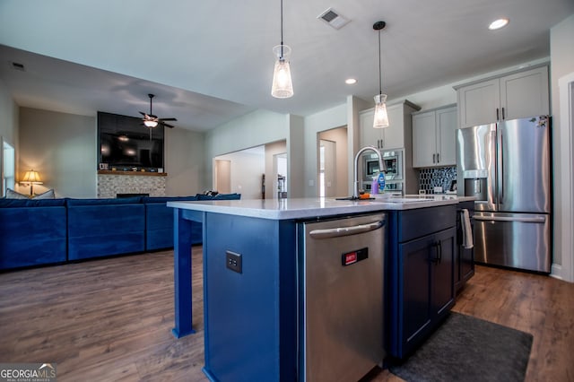 1291 Pleasant Grove Church Rd, Villa Rica, GA 30180 - kitchen featuring dark hardwood / wood-style floors, an island with sink, a breakfast bar area, hanging light fixtures, and stainless steel appliances