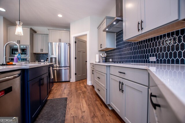 1291 Pleasant Grove Church Rd, Villa Rica, GA 30180 - kitchen featuring wall chimney range hood, decorative backsplash, hanging light fixtures, and appliances with stainless steel finishes