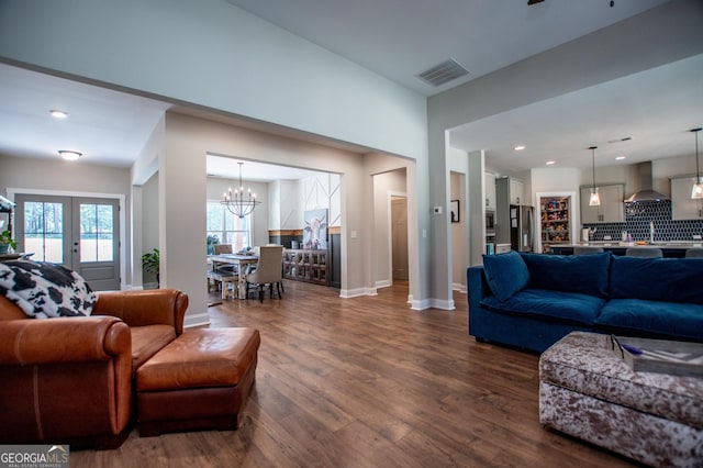 1291 Pleasant Grove Church Rd, Villa Rica, GA 30180 - living room featuring a notable chandelier, dark hardwood / wood-style floors, and french doors