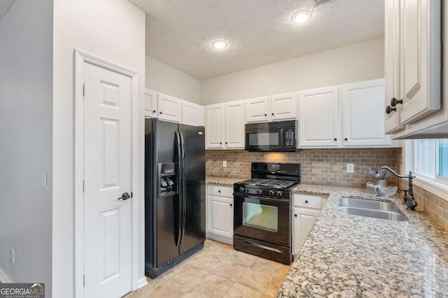 kitchen featuring white cabinetry, sink, and black appliances