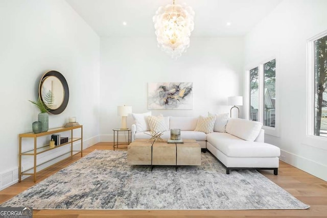 sitting room featuring an inviting chandelier and light wood-type flooring