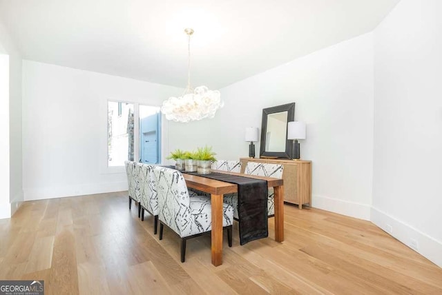 dining room featuring a notable chandelier and light hardwood / wood-style floors