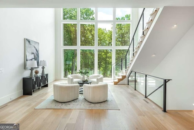 interior space featuring a high ceiling and light hardwood / wood-style flooring