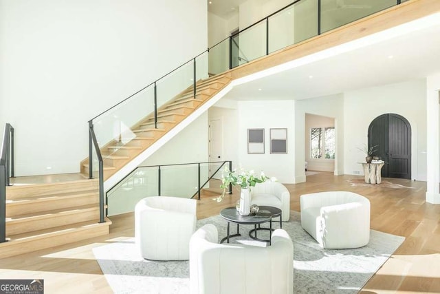 interior space featuring hardwood / wood-style floors and a high ceiling