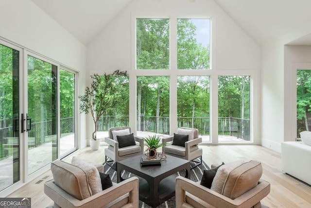 sunroom / solarium featuring vaulted ceiling