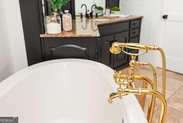 bathroom with vanity and a tub