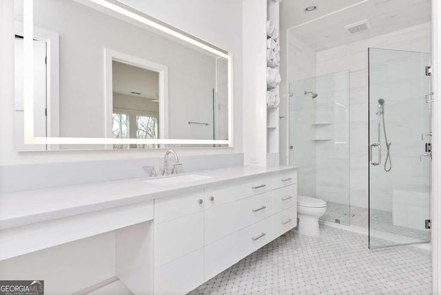 bathroom with vanity, an enclosed shower, and toilet