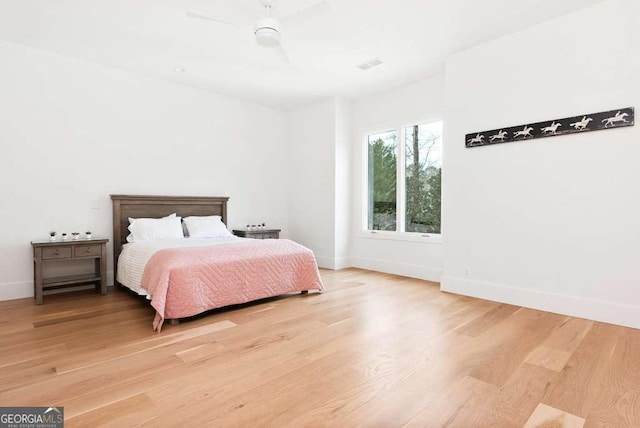 bedroom with hardwood / wood-style floors and ceiling fan