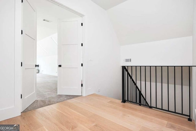 bonus room featuring hardwood / wood-style flooring and vaulted ceiling