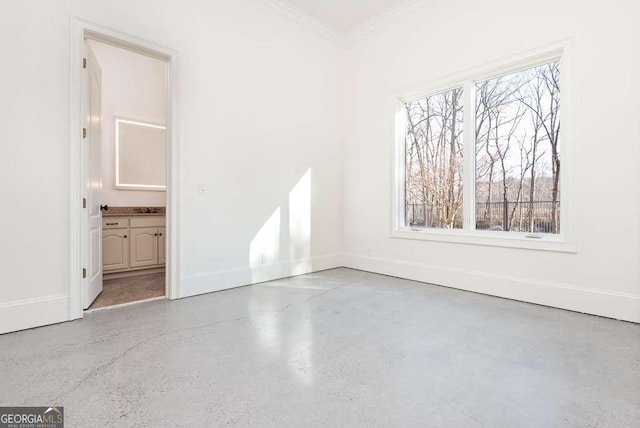 unfurnished room with ornamental molding and a healthy amount of sunlight