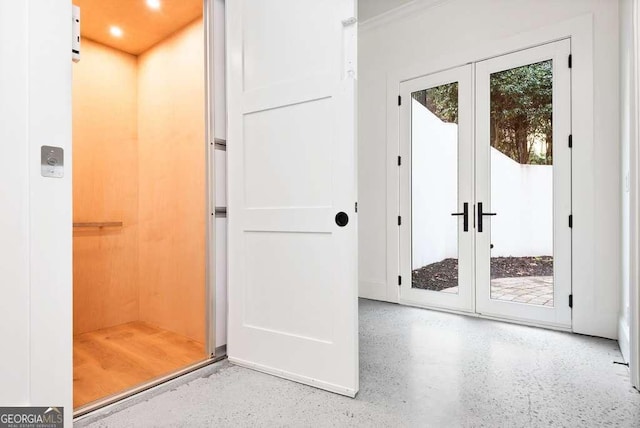 entryway with a wealth of natural light, french doors, and elevator