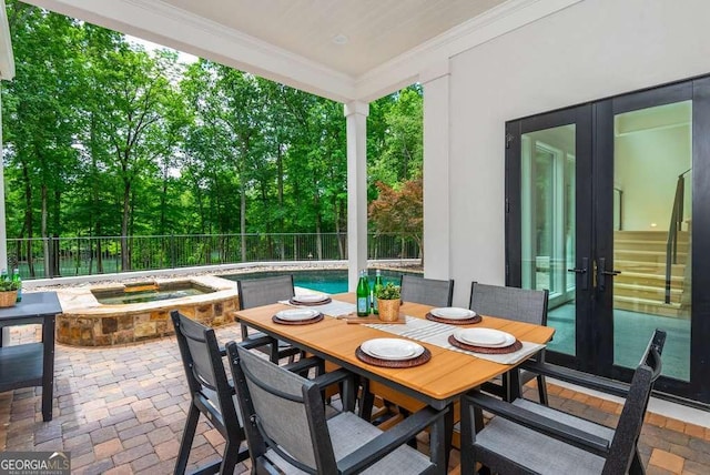 exterior space featuring a pool with hot tub and french doors