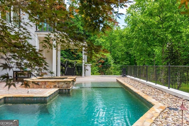 view of pool featuring an in ground hot tub and a patio