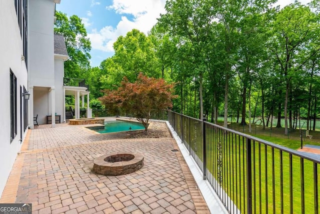 view of pool with a patio, a fire pit, and a lawn