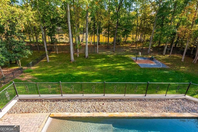 surrounding community featuring a swimming pool and a yard