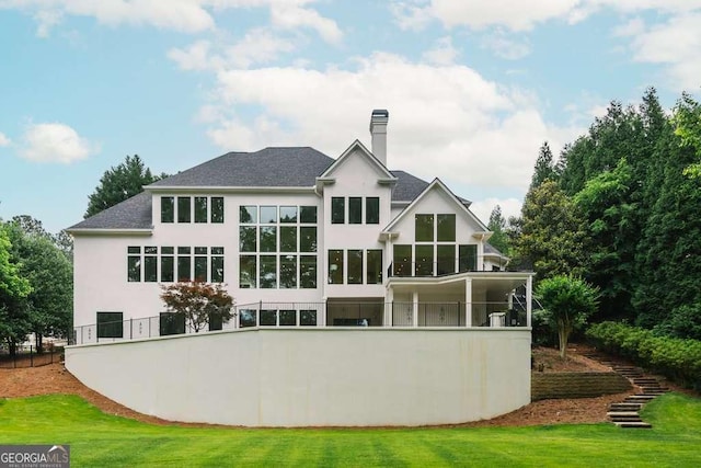 back of house featuring a lawn