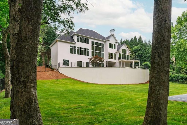 back of house featuring a yard