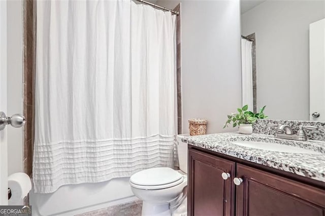 full bathroom featuring vanity, shower / tub combo, and toilet