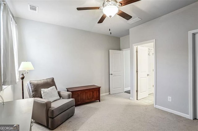 sitting room featuring light colored carpet and ceiling fan