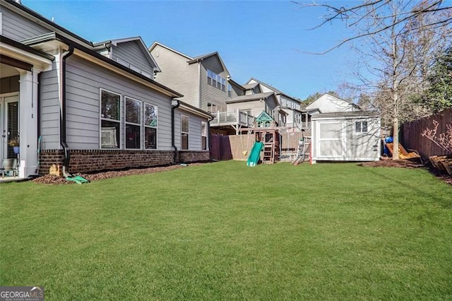 view of yard with a playground and a storage shed