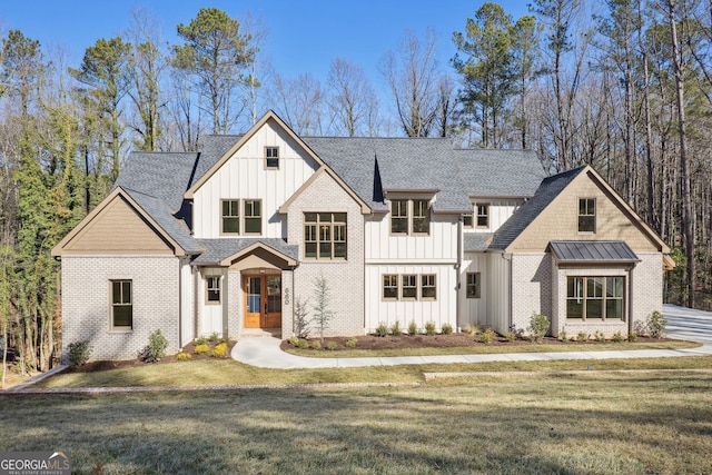 modern farmhouse style home with a front yard