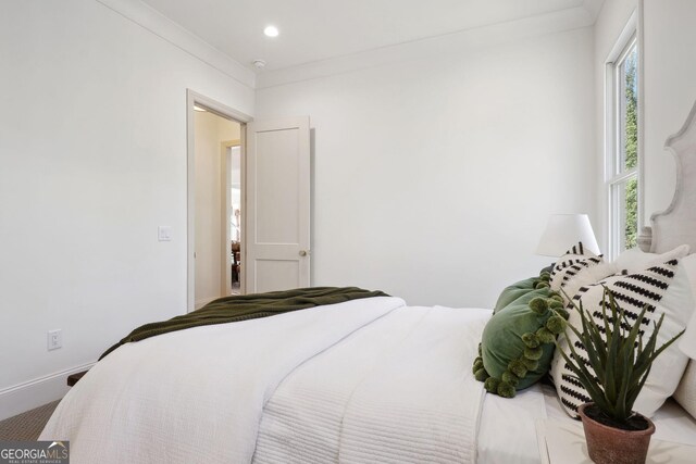 bedroom with ornamental molding