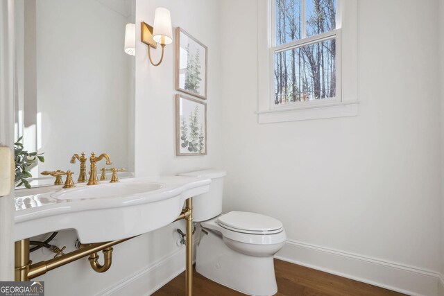 bathroom featuring wood-type flooring and toilet