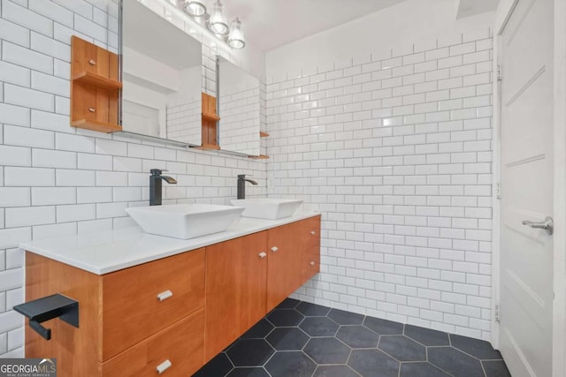 bathroom with tile patterned flooring, vanity, and tile walls