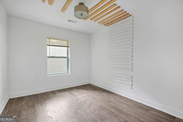 spare room with hardwood / wood-style floors