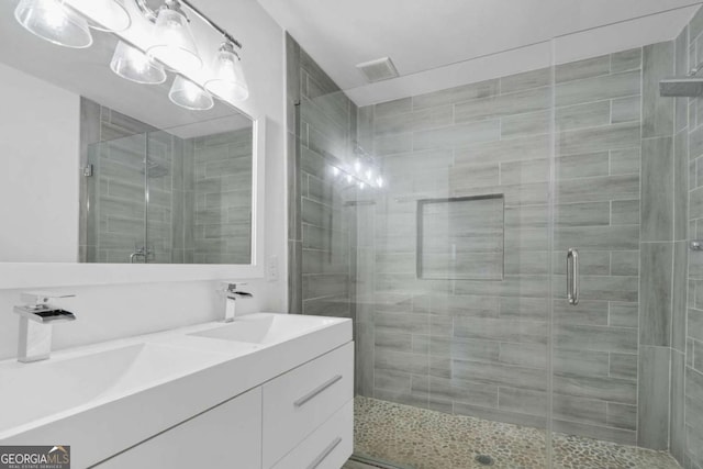 bathroom featuring vanity and an enclosed shower