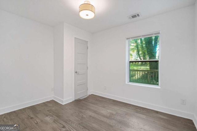 empty room featuring dark hardwood / wood-style flooring