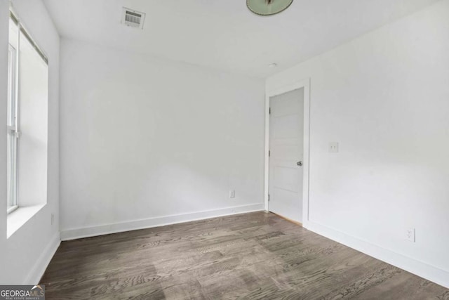 spare room with dark wood-type flooring