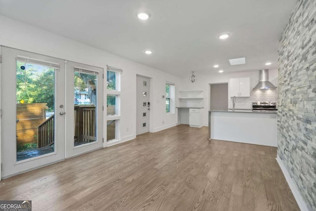 unfurnished living room with light wood-type flooring