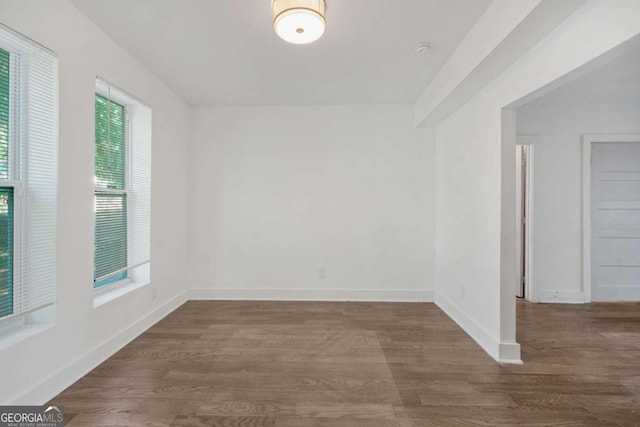 spare room with dark hardwood / wood-style floors