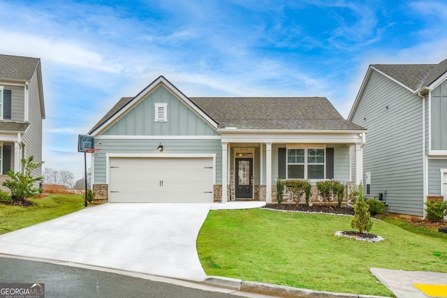 craftsman-style home with an attached garage, concrete driveway, board and batten siding, and a front yard