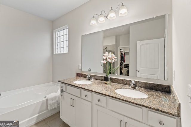 bathroom featuring vanity, a bathing tub, and tile patterned flooring