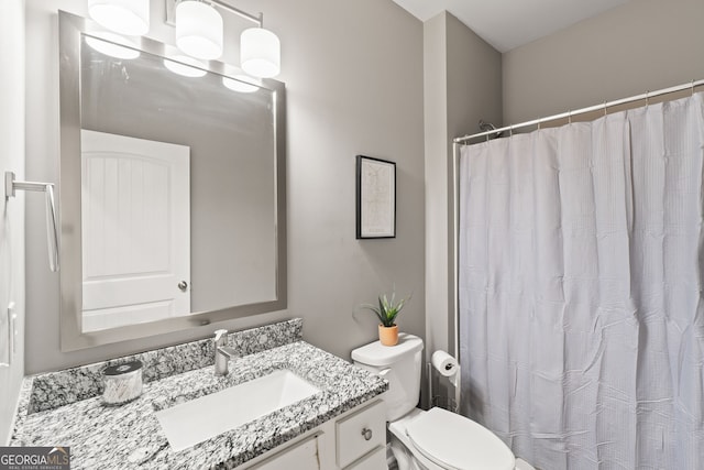 bathroom featuring vanity and toilet