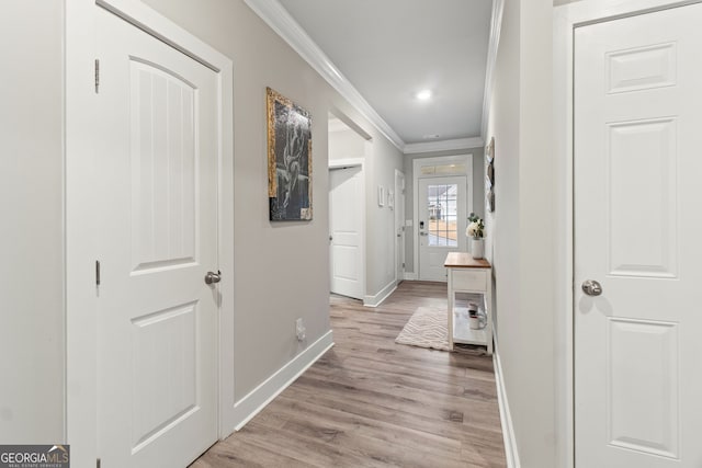 hallway with crown molding and light wood-type flooring